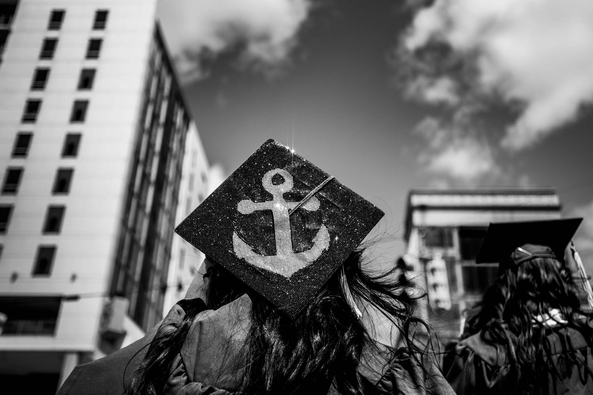 A closeup of a graduate's cap bedazzled with the shape of an anchor.